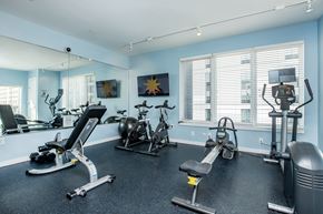 Raleigh apartment for rent - A gym with a variety of exercise equipment including treadmills, stationary bikes, and weight machines.