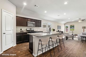Conroe apartment for rent - A kitchen with a white counter top and black cabinets.