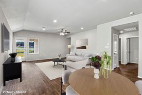 Conroe apartment for rent - A living room with a couch, a coffee table, and a ceiling fan.