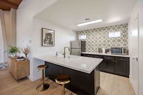 Henderson apartment for rent - A kitchen with a white countertop and black cabinets.