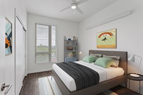 Portland apartment for rent - a bedroom with a large window and a ceiling fan