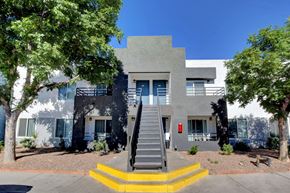 Henderson apartment for rent - A modern house with a grey facade and a staircase leading to the entrance.