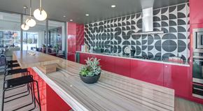 Los Angeles apartment for rent - A modern kitchen with a wooden counter and red accents.