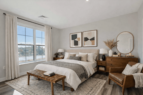 Fairfield apartment for rent - Staged apartment bedroom with large window and modern furnishings at Creekline at Fairfield in Fairfield, Connecticut.