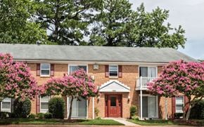 Chesapeake apartment for rent - a brick house with pink flowers in front of it