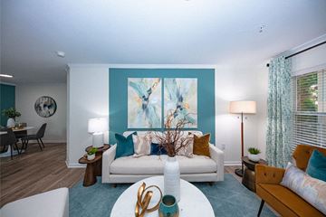 Murfreesboro apartment for rent - A living room with a white couch and a painting on the wall.