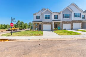 Taylors apartment for rent - New townhomes for rent with white siding, brick accents, and attached garages.