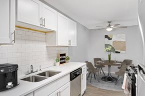 Minnetonka apartment for rent - Stratford Wood Apartments and Townhomes in Minnetonka, MN Photo of  an open kitchen and dining area with a table and chairs and a sink