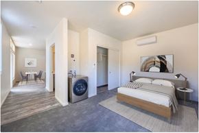 Gresham apartment for rent - a bedroom with a bed and a washing machine in a room