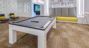 Los Angeles apartment for rent - A pool table in a room with a bench and a drawing on the wall.