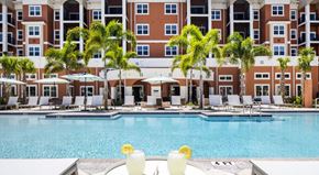 Championsgate apartment for rent - Two drinks are on a table by a pool.
