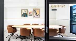 Seattle apartment for rent - A conference room with a table and chairs and a sign that says GATHER.