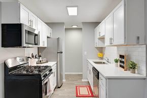 Minnetonka apartment for rent - Stratford Wood Apartments and Townhomes in Minnetonka, MN Photo of kitchen with white cabinets and stainless steel appliances