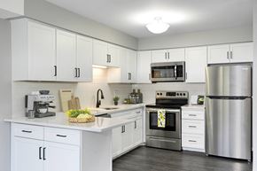 Golden Valley apartment for rent - Laurel West End Apartments in Golden Valley, MN photo of kitchen with white cabinets, stainless-steel appliances and hardwood flooring