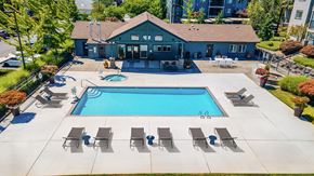 Vancouver apartment for rent - A pool with lounge chairs and a building in the background.