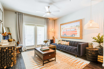 Midland apartment for rent - A living room with a dark blue sofa and a coffee table with a book on it.