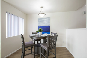 Tucson apartment for rent - Dining room with window and wood-style flooring at Midtown on Seneca, a pet-friendly apartment community near East Central Tucson, Tucson, AZ.