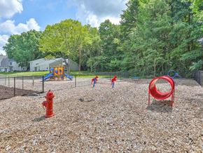 Charlotte apartment for rent - a playground with a fire hydrant in the foreground and trees in the background