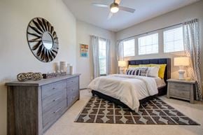 Huntersville apartment for rent - Large bedroom with windows and modern furnishings