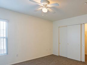 Reno apartment for rent - a bedroom with a ceiling fan and a closet