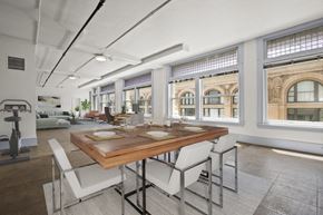 Los Angeles apartment for rent - a dining room with a wooden table and white chairs