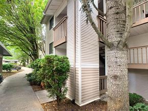 Everett apartment for rent - a side view of a building with trees and a sidewalk