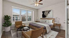 Lewisville apartment for rent - a bedroom with a bed and a ceiling fan