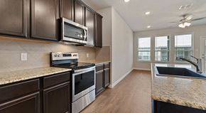 Lewisville apartment for rent - a kitchen with stainless steel appliances and granite counter tops