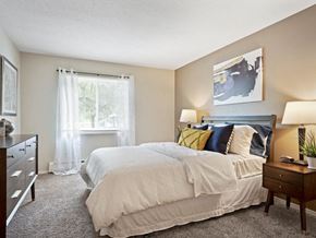 Fridley apartment for rent - a bedroom with a bed and a dresser