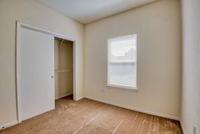 Beaumont apartment for rent - Apartments In Beaumont, TX for Rent – Breakwater Bay - Bedroom with plush carpet, closet for storage, and window with coverings