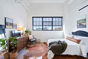 Minneapolis apartment for rent - a bedroom with a bed and a large window