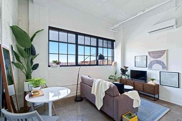 Minneapolis apartment for rent - a living room with a couch and a table and a window