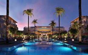 Las Vegas apartment for rent - A pool surrounded by palm trees and lit up with blue lights.