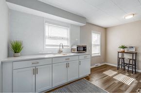 Winchester apartment for rent - A kitchen with white cabinets and a microwave on the counter.