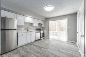 Winchester apartment for rent - A kitchen with white cabinets and a stainless steel refrigerator.