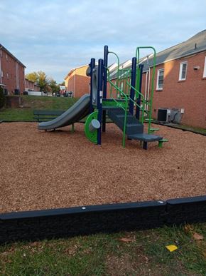 Winchester apartment for rent - A playground with a green slide and a blue and green climbing frame.