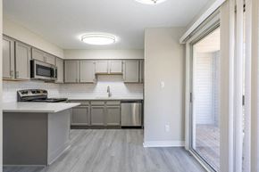 Newport News apartment for rent - A modern kitchen with a white countertop and stainless steel appliances.
