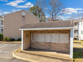 Newport News apartment for rent - A brick building with a white awning and a calendar on the wall.