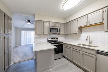 Newport News apartment for rent - A kitchen with a stove top oven and a microwave built into the cabinetry.