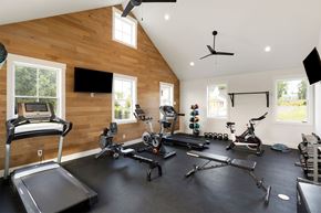 Maple Grove apartment for rent - A spacious home gym with a variety of exercise equipment.