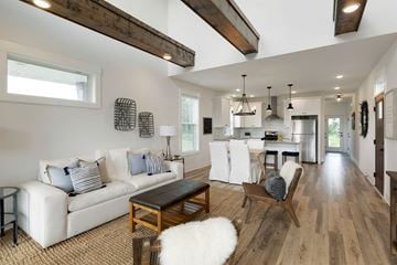 Maple Grove apartment for rent - A modern living room with a white couch and wooden floors.
