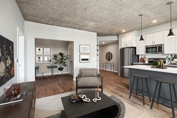 Madison apartment for rent - A modern living room with a grey armchair and a coffee table in the center.