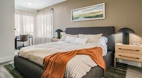 Henderson apartment for rent - A bedroom with a large bed and a painting on the wall.