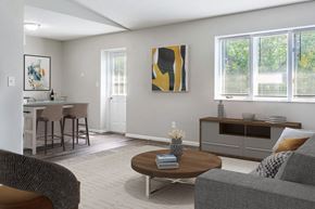 Springfield apartment for rent - A living room with a grey couch, a brown coffee table, and a painting on the wall.