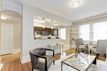 Washington apartment for rent - A modern living room with a glass coffee table and a black leather chair.