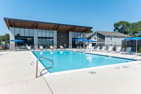 Plainsboro Township apartment for rent - A large swimming pool with a building in the background.
