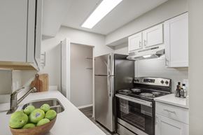 Raleigh apartment for rent - the timbers raleigh nc apartments for rent kitchen with stainless steel appliances and white cabinets with stone counter tops and pantry