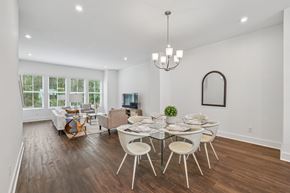Avondale Estates townhouse for rent - A dining room with a glass table and white chairs.