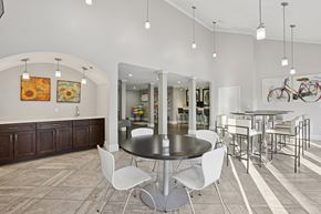 Lawrenceville townhouse for rent - A modern dining room with a round table and white chairs.