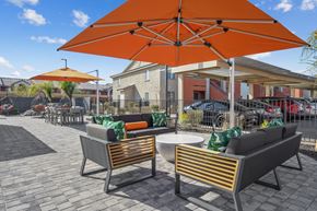Las Vegas apartment for rent - Two chairs and a table are under an orange umbrella.
